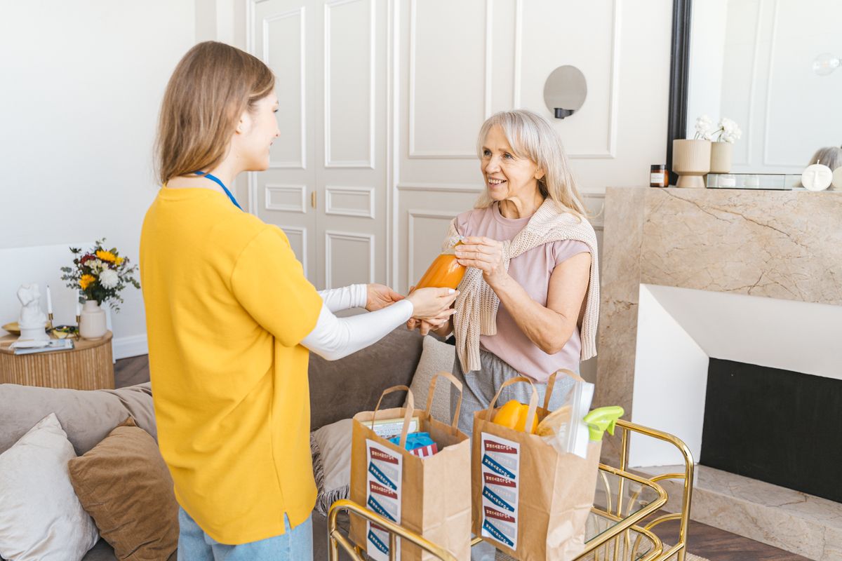 Caregiver helping a client with groceries and errands